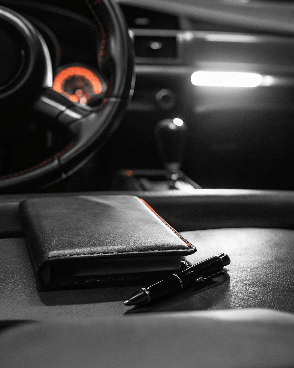 Steering wheel and instrument cluster with a leather notebook on the passenger seat